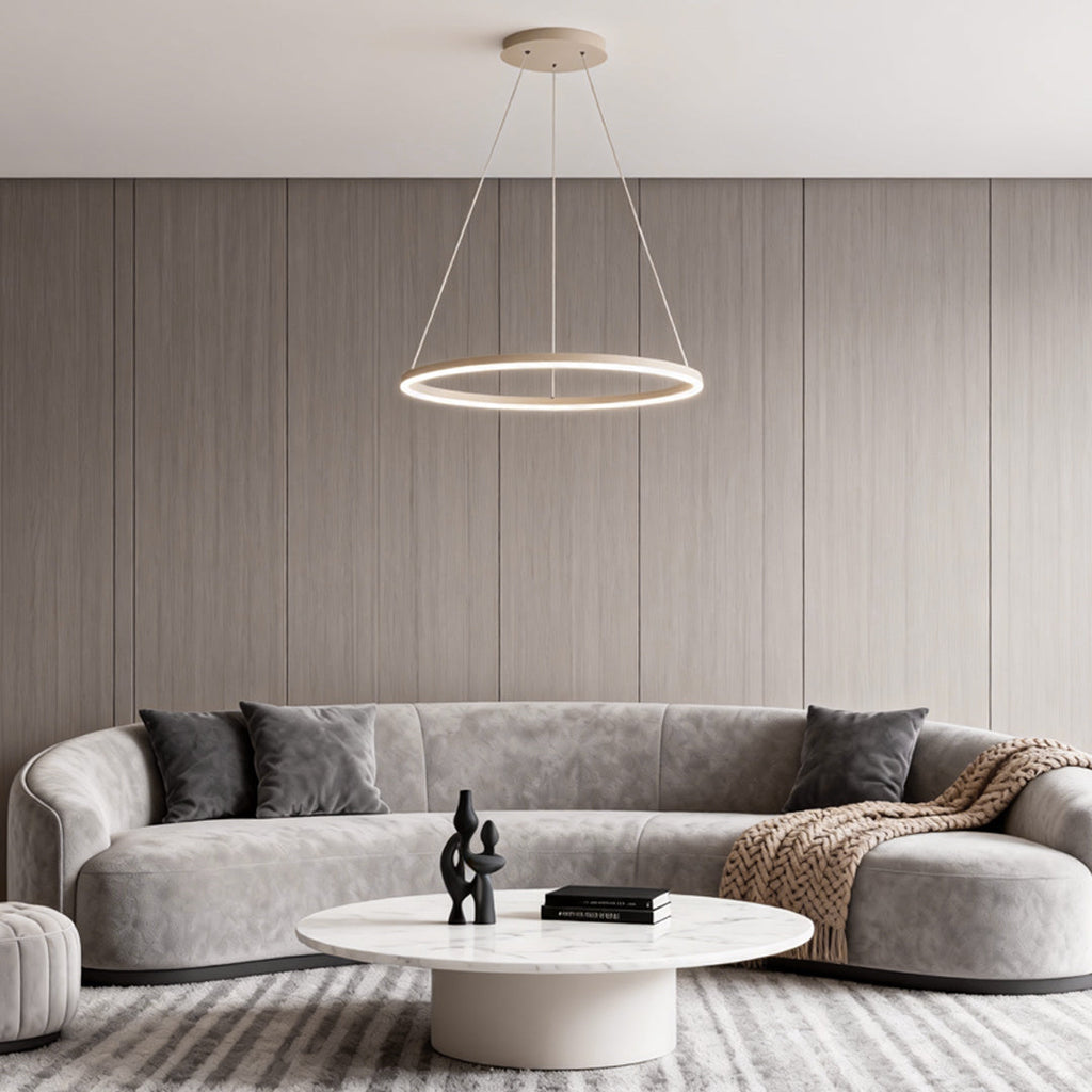 Black LED ring chandelier hanging in a neutral-toned living room with curved sofa design.