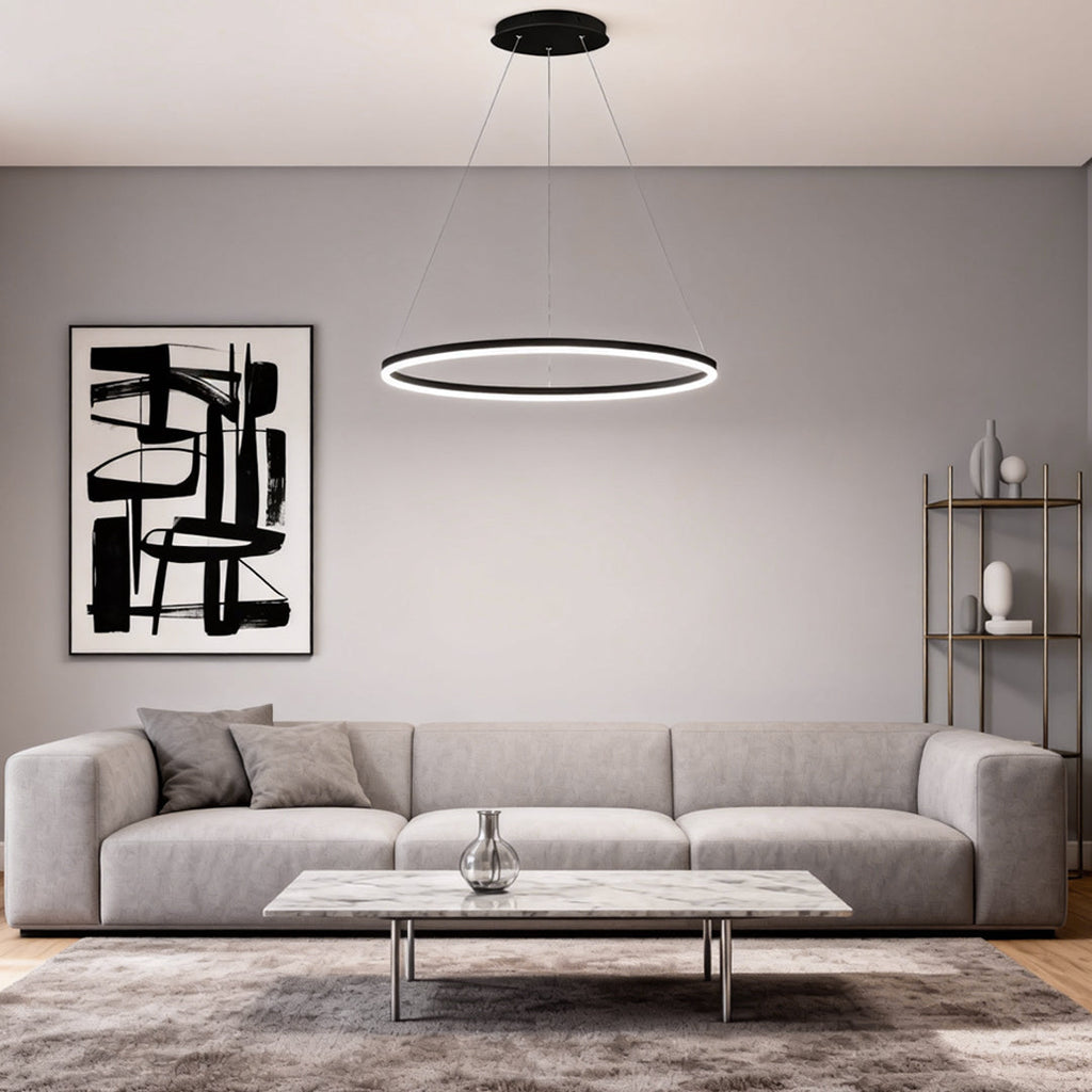 Black LED ring chandelier centered above a modern gray sofa in a contemporary interior.