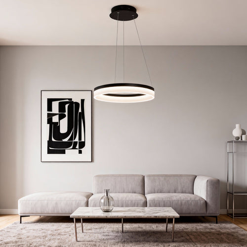 Modern black ring pendant light installed above a minimalist living room sofa with soft ambient lighting.