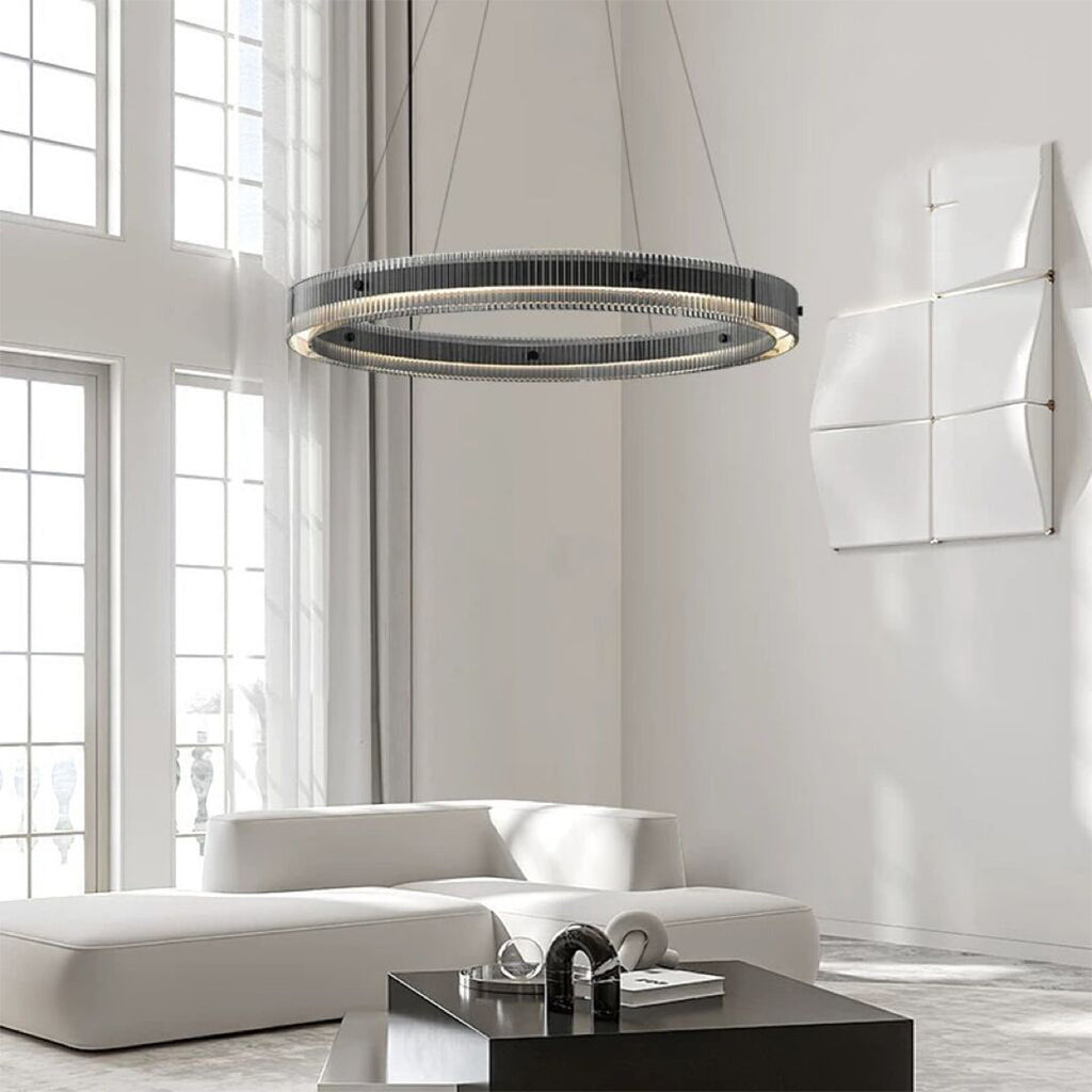 Black round pendant light installed in bright modern living room with floor-to-ceiling windows