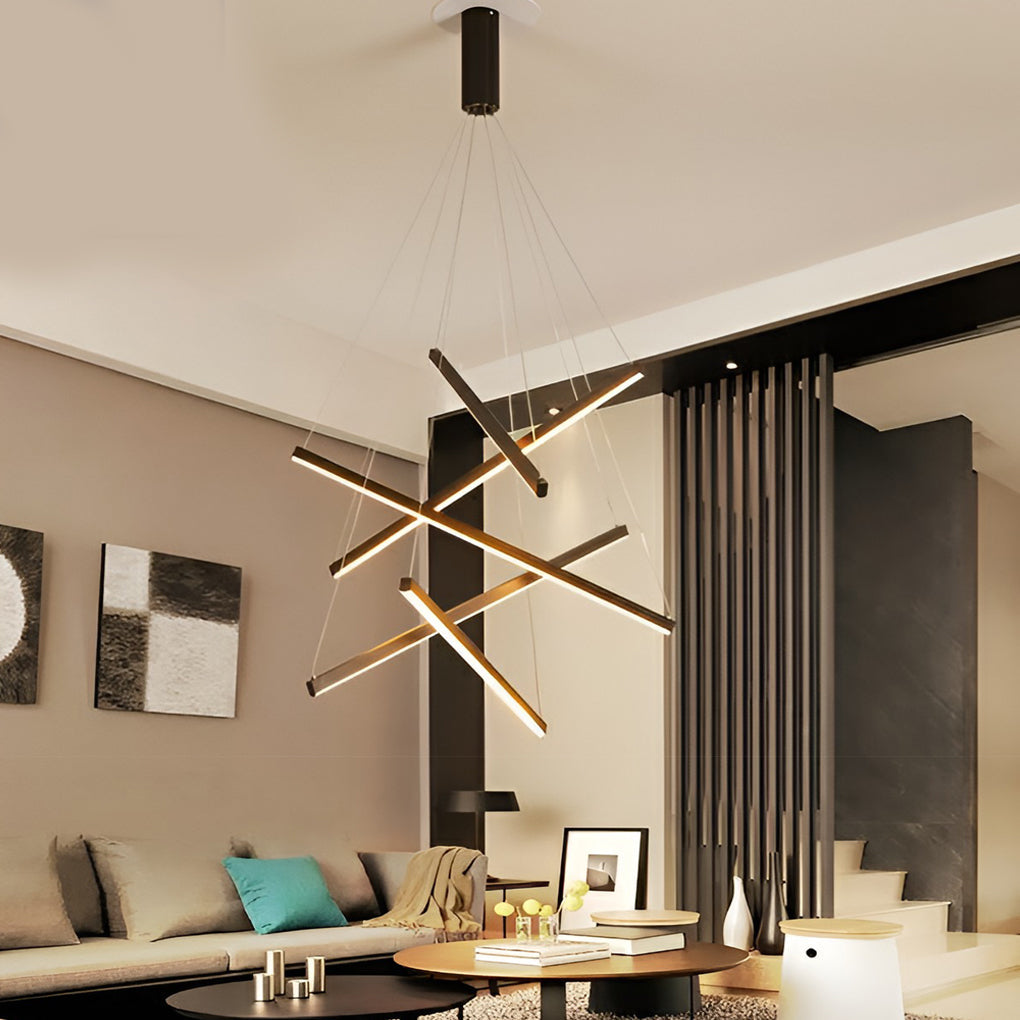 Criss linear chandelier with gold and black accents, hanging above a contemporary dining area.