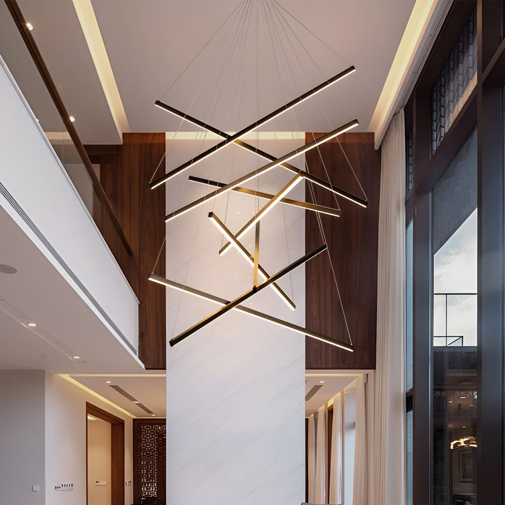 Criss linear chandelier featuring a sleek gold and black design, illuminating a modern interior space.