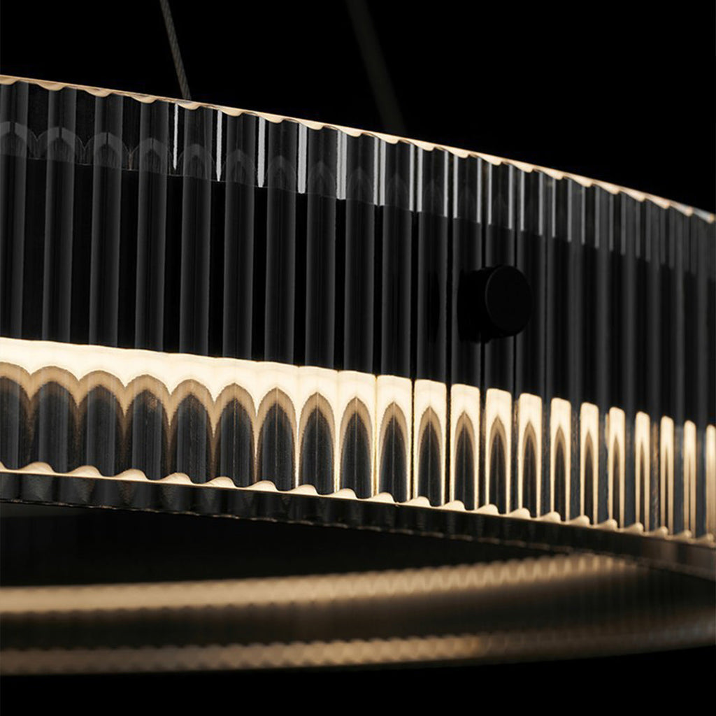 Dramatic black round pendant light installation with artistic lighting elements and modern architecture