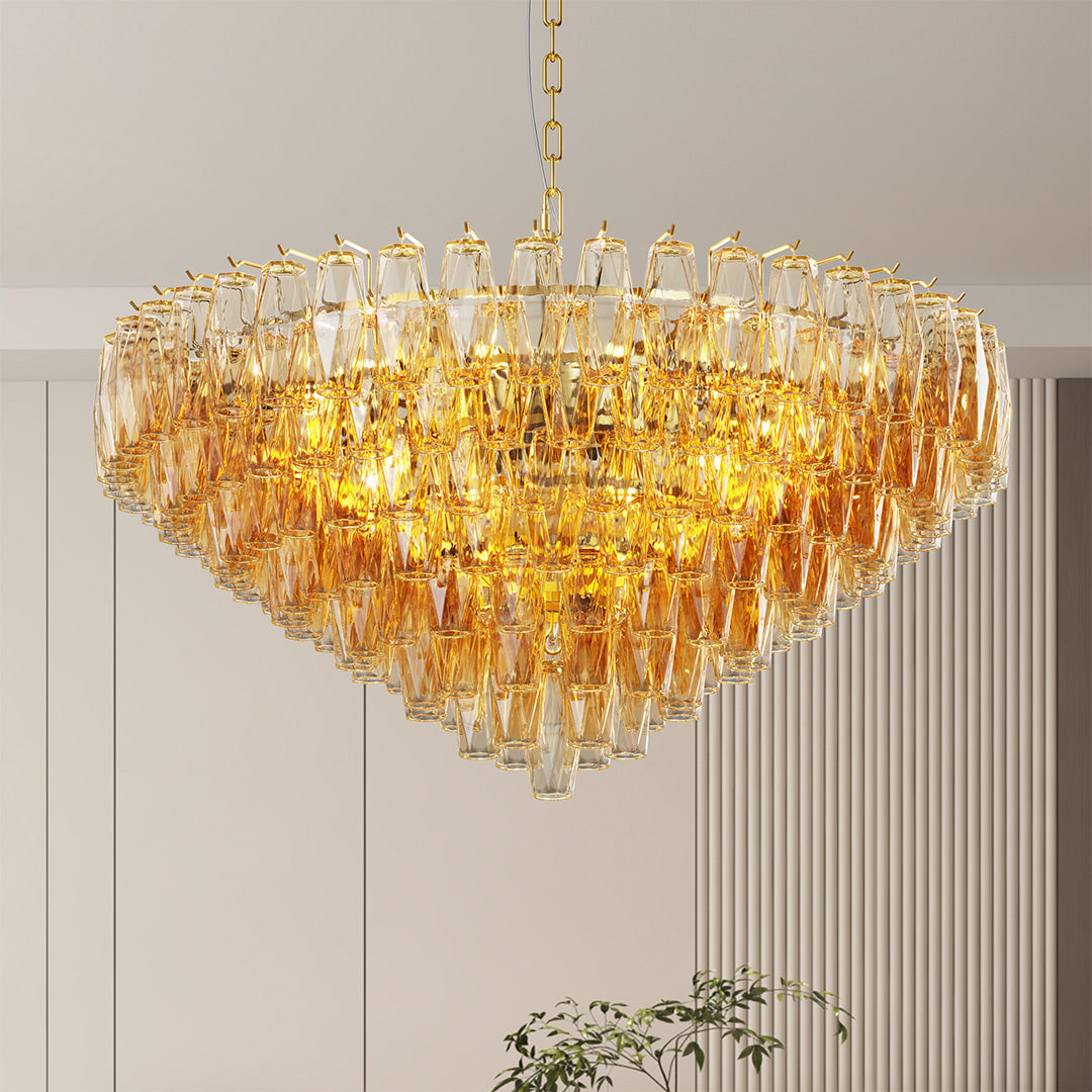 Round layered glass pendant chandelier with gold frame creating a luxurious glow in living room.