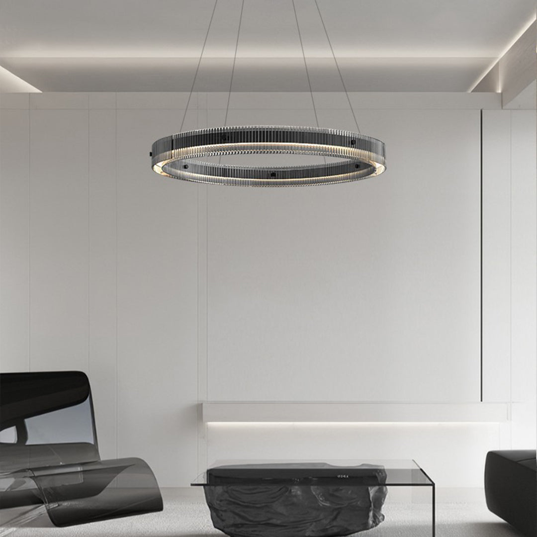 Modern black round pendant light illuminating sleek contemporary living space with neutral tones