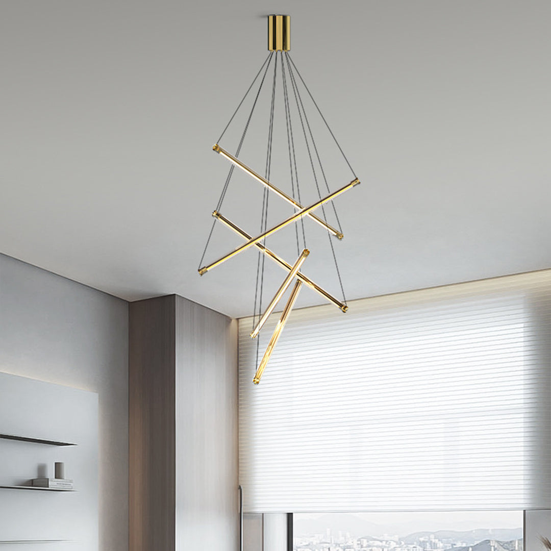 Sleek LED linear chandelier with gold finish and intersecting bars, installed in a two-story modern living room.